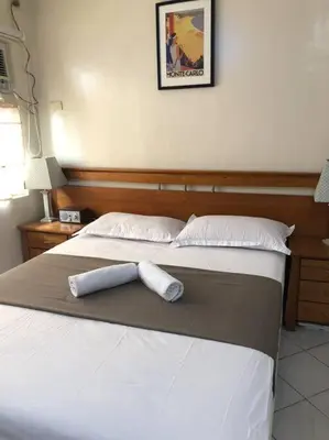 a bed with two rolled up towels on it at 3BR 70sqm Free internet, Penthouse unit in Ermita, Manila near US Embassy in Manila