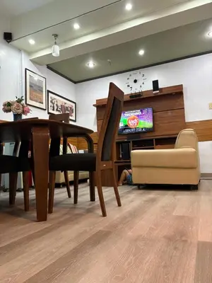 a dining room with a table and a tv at 3BR 70sqm Free internet, Penthouse unit in Ermita, Manila near US Embassy in Manila