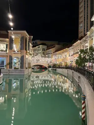 a pool of water in a city at night at 1BR Studio at viceroy McKinley taguig in Manila