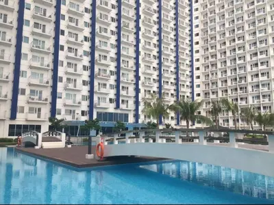 a swimming pool in front of a large building at Ronnzel staycation in Jazz Residence Makati in Manila