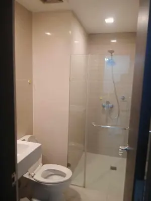 a bathroom with a shower with a toilet and a sink at 101 condo furnished walking distance NIAA 3 in Manila
