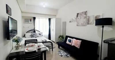 a small room with a bed and a couch at LukeatSkye Suite - The Beacon Makati in Manila