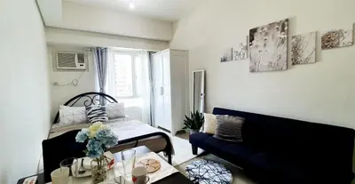 a living room with a bed and a couch at LukeatSkye Suite - The Beacon Makati in Manila