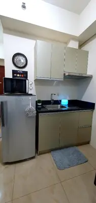 a small kitchen with a sink and a refrigerator at LukeatSkye Suite - The Beacon Makati in Manila