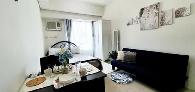 a living room with a couch and a table at LukeatSkye Suite - The Beacon Makati in Manila