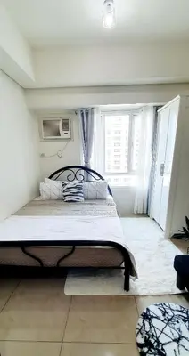 a bedroom with a large bed in a room at LukeatSkye Suite - The Beacon Makati in Manila