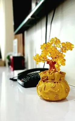 a gold plant on a desk next to a phone at Belles Home Relaxing Place SMDC Hope Residences in Trece Martires