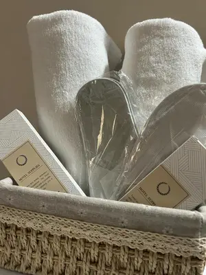 a basket with towels and certificates in it at Belles Home Relaxing Place SMDC Hope Residences in Trece Martires