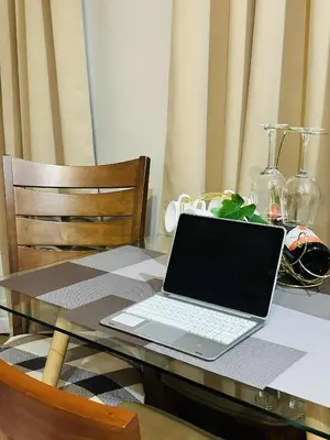 a laptop computer sitting on top of a table at Belles Home Relaxing Place SMDC Hope Residences in Trece Martires
