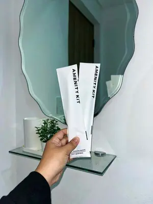 a person holding up a book in front of a mirror at Belles Home Relaxing Place SMDC Hope Residences in Trece Martires