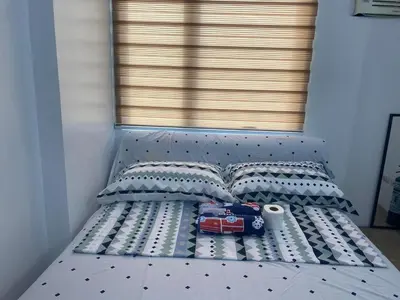 a bed with a toy car and two pillows at Staycation budget room in Manila