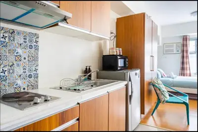 a small kitchen with a sink and a refrigerator at Staycation in Manila (2 min. walk to Robinson's) in Manila