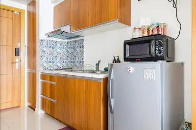 a kitchen with a refrigerator and a microwave on top of it at Staycation in Manila (2 min. walk to Robinson's) in Manila
