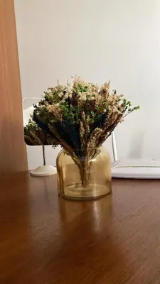 a glass vase with flowers in it on a table at Staycation in Manila (2 min. walk to Robinson's) in Manila