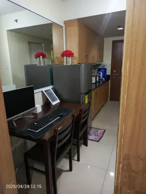 a kitchen with a desk with a computer on it at Nice and Simple 1 Bedroom in Shell Residences in Manila