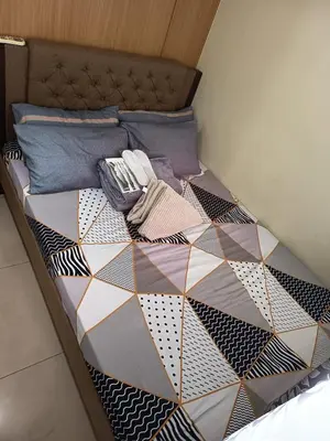 a bedroom with a bed with a hexagonal pattern at Nice and Simple 1 Bedroom in Shell Residences in Manila