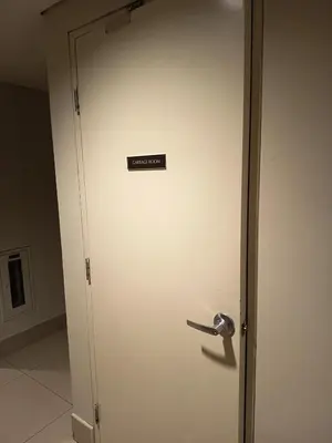 a white door with a sign on it at Nice and Simple 1 Bedroom in Shell Residences in Manila