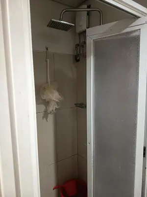 a bathroom with a shower with a glass door at Nice and Simple 1 Bedroom in Shell Residences in Manila