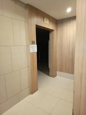 a hallway with a door leading into a dark room at Nice and Simple 1 Bedroom in Shell Residences in Manila