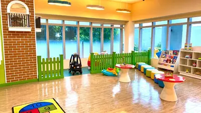 a room with a play area with tables and chairs at Lovely 1 Bedroom City View in Uptown BGC in Manila
