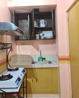 a small kitchen with a stove and a sink at Affordable Transient along Ortigas Ext near Cainta/Pasig in Cainta
