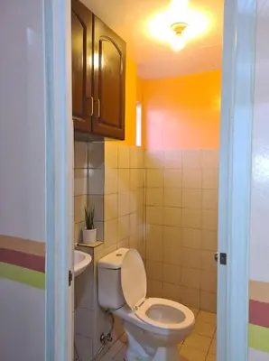 a bathroom with a toilet and a sink at Budget Friendly Condo for Rent in Valley Golf in Cainta
