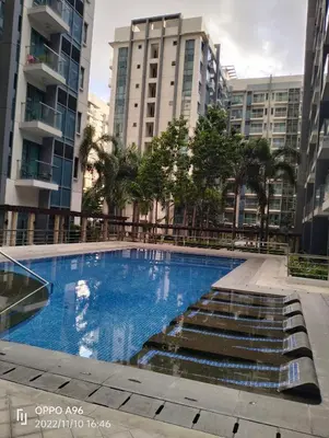 a swimming pool in a city with tall buildings at RQUI CONDOTEL NEAR AIRPORT & Resorts World Manila in Manila