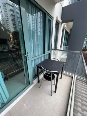 a black table and chair on the balcony of a building at 2 Palm Tree Villas - Manila Terminal 3 Airport Pasay in Manila