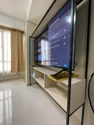 a large flat screen tv on a stand in a room at U806 2Bedrooms PoolAccess Netflix wifi85mbps Karaoke in Manila