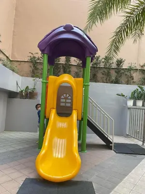 a small playground with a yellow and purple slide at U806 2Bedrooms PoolAccess Netflix wifi85mbps Karaoke in Manila