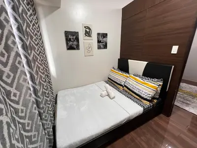 a bed with a teddy bear on it in a room at Air Residences - 1Bedroom Unit with Balcony - Wifi & Netflix in Manila