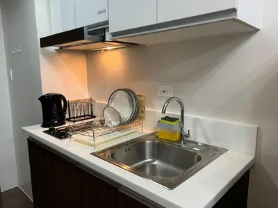 a kitchen with a sink and a counter top at Air Residences - 1Bedroom Unit with Balcony - Wifi & Netflix in Manila