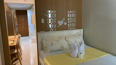 a small bedroom with a bed with shoes on it at SHELL RESIDENCE c7 shortwalk MALL OF ASIA in Manila
