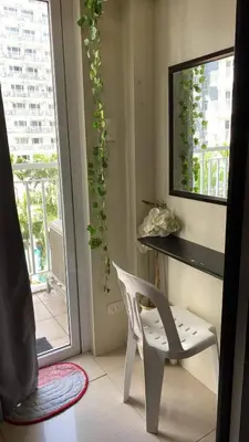 a white chair in a room with a window at SHELL RESIDENCE c7 shortwalk MALL OF ASIA in Manila