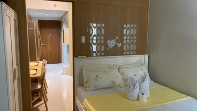 a bedroom with a bed with towels on it at SHELL RESIDENCE c7 shortwalk MALL OF ASIA in Manila