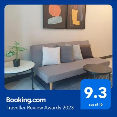 a living room with a couch and a table at Uptown Parksuites Tower 1 BGC in Manila