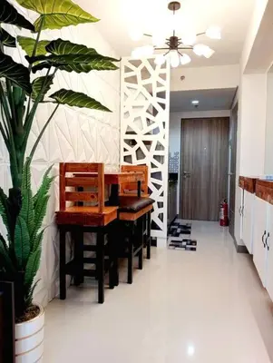 a dining room with a table and a plant at MOA S Residences 1BR Condo Stunning Boutique T3 in Manila