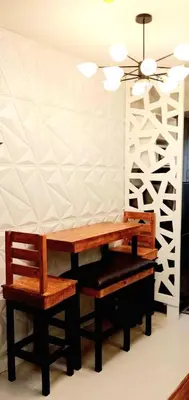 two benches sitting next to a wall with a ceiling fan at MOA S Residences 1BR Condo Stunning Boutique T3 in Manila