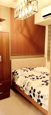 a bedroom with a bed and a chandelier at MOA S Residences 1BR Condo Stunning Boutique T3 in Manila