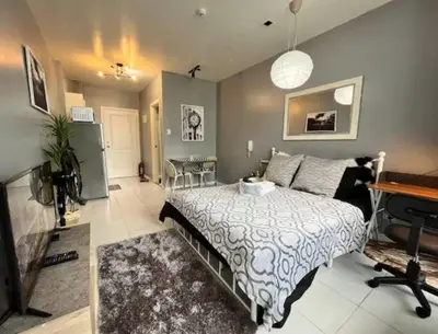 a bedroom with a bed and a piano in it at Makati - Sleeps 2 - Pool - Cinema - Gym - Garden in Manila