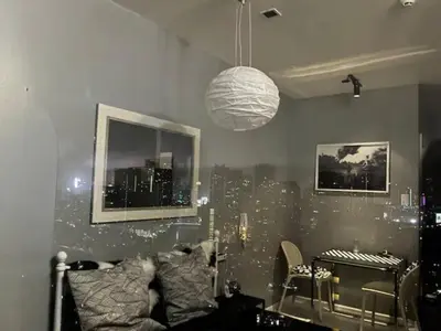 a living room with a city mural on the wall at Makati - Sleeps 2 - Pool - Cinema - Gym - Garden in Manila