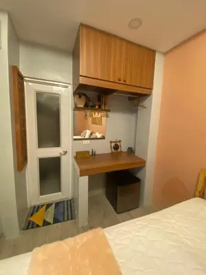 a small room with a desk and a window at Rain Airport Bed and Breakfast in Manila