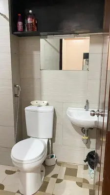 a bathroom with a toilet and a sink at staycation affordable alabang in Manila