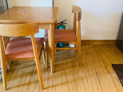 a wooden table and two chairs sitting next to a table at Azure Residence B1 Free wi-fi Near Sm Mall Airport in Manila