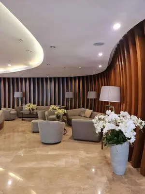 a living room with couches and tables and flowers at Staycation by Janeil at Shore 2 Residences SMDC, MOA Complex, Pasay City, Philippines in Manila