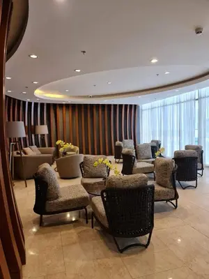 a lobby with a waiting room with chairs and tables at Staycation by Janeil at Shore 2 Residences SMDC, MOA Complex, Pasay City, Philippines in Manila
