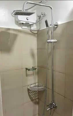 a shower in a bathroom with a glass door at Staycation by Janeil at Shore 2 Residences SMDC, MOA Complex, Pasay City, Philippines in Manila