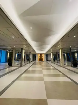 an empty hallway in a building with ailed floor at Stylish 1 bedroom condo with pool view and Fast WIFI in Manila