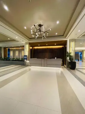 a lobby with a large room with a chandelier at Stylish 1 bedroom condo with pool view and Fast WIFI in Manila