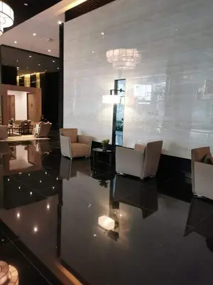 a lobby with couches and chairs in a building at Cruz Air Residences in Manila